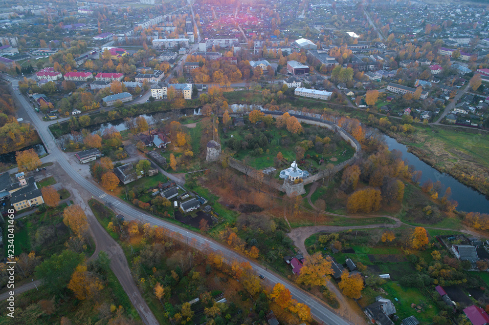 Porkhov fortress in the city panorama in the autumn evening. Porkhov, Russia