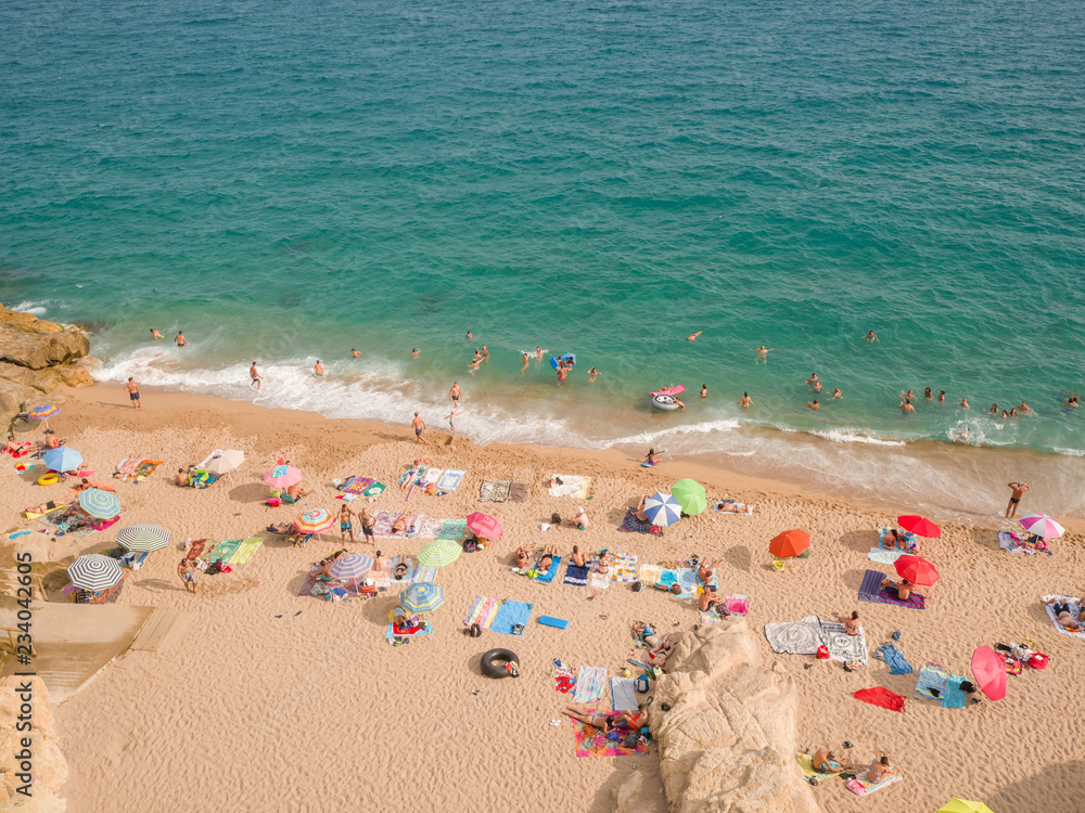 People at beach in Calella city. Spain.