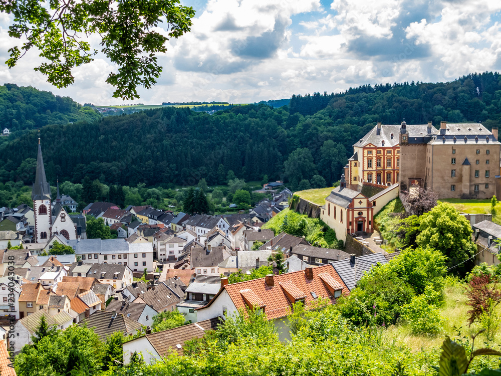 Elevated view to the village of Malberg in Rhineland-Palatinate, Germany and Malberg Castle to the right under overcast summer sky