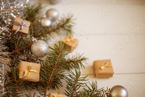 fir branches are decorated with Christmas balls  boxes  background for Christmas texts with free space  horizontally  toned 