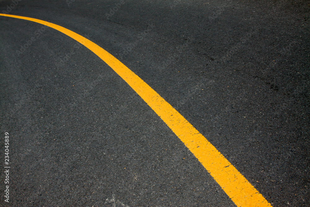 Yellow line on the asphalt road Yellow line on the asphalt road