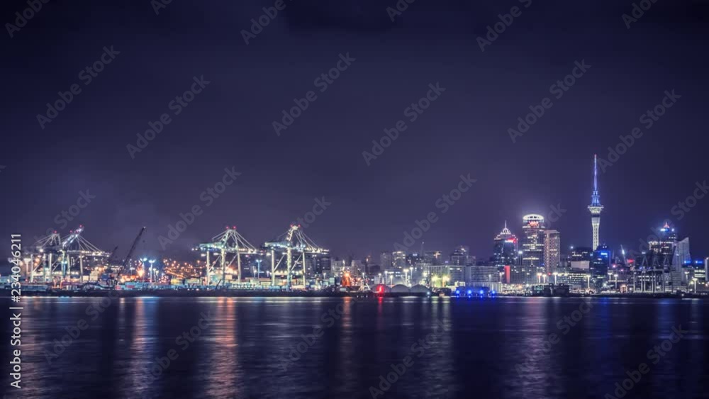 Timelapse of Auckland, New Zealand at night with bright lights of its business city centre on the right side and busy industrial harbor on the left. Timelapse of Auckland, New Zealand at night with bright lights of its business city centre on the right side and busy industrial harbor on the left.