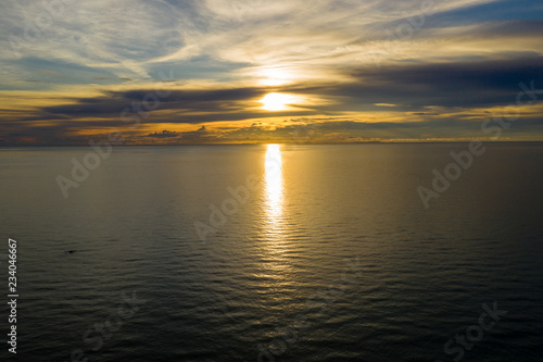 Aerial view of sunset over a tropical ocean