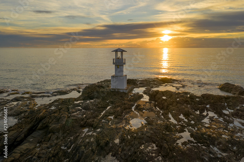 Aerial drone view of a lighthouse at sunset over a tropical ocean (Khao Lak, Thailand)