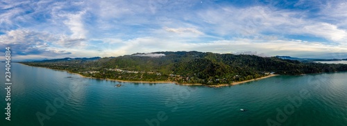 Aerial panoramic view of a tropical beach, jungle and town at sunset (Khao Lak, Thailand) © whitcomberd
