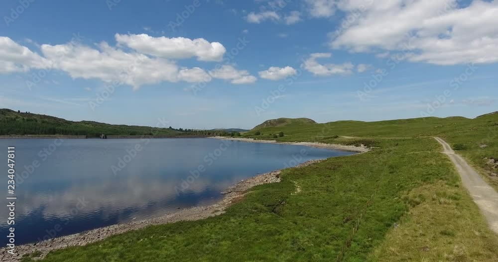 Drone Shot on a Sunny Day over a Small Lake Moving towards Forest Drone Shot on a Sunny Day over a Small Lake Moving towards Forest
