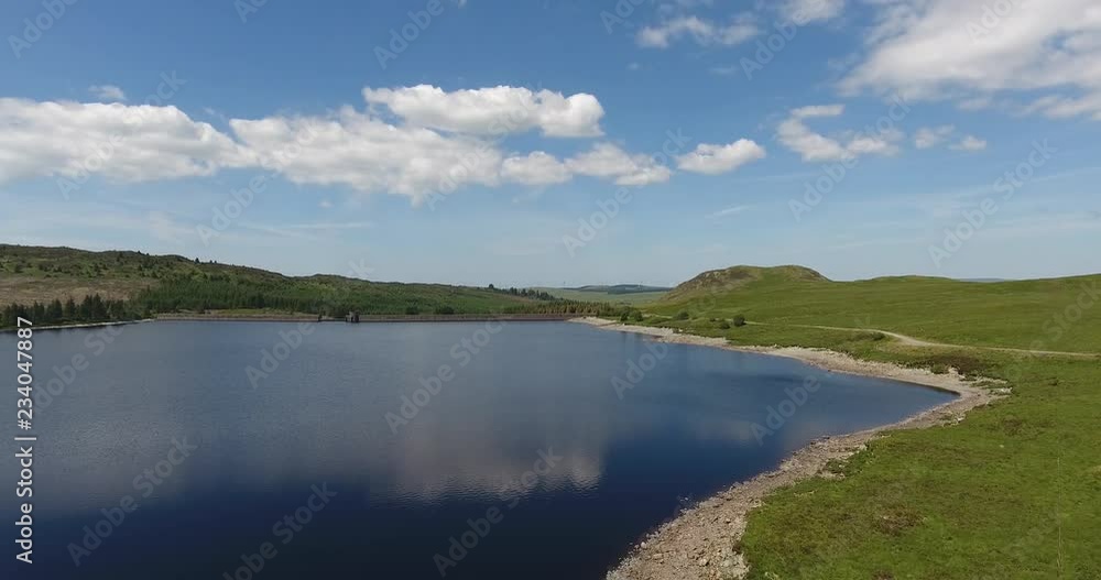 Drone Shot on a Sunny Day over a Small Lake Moving towards Forest Drone Shot on a Sunny Day over a Small Lake Moving towards Forest