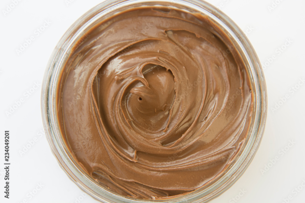 Chocolate hazelnut spread in glass bowl. Hazelnut Nougat cream. Chocolate hazelnut spread in glass bowl. Hazelnut Nougat cream.