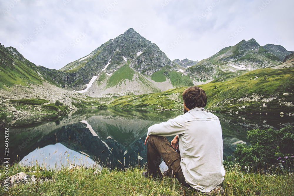 Man enjoying landscape traveling alone adventure vacations solitude lifestyle outdoor silence lake and mountains reflection landscape