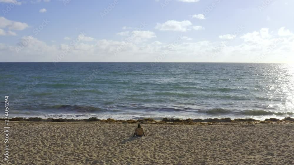 View at sunny sand beach and rolling waves in Miami in USA View at sunny sand beach and rolling waves in Miami in USA