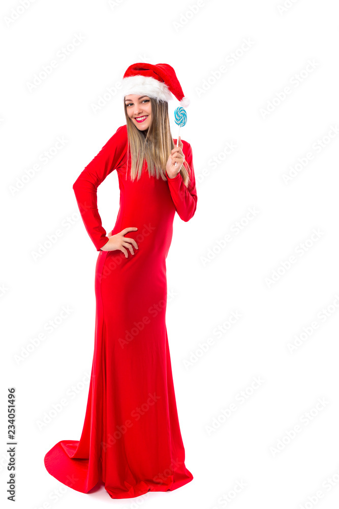 Full length portrait of beautiful girl in long red dress with santa hat holding a lollipop over white Full length portrait of beautiful girl in long red dress with santa hat holding a lollipop over white