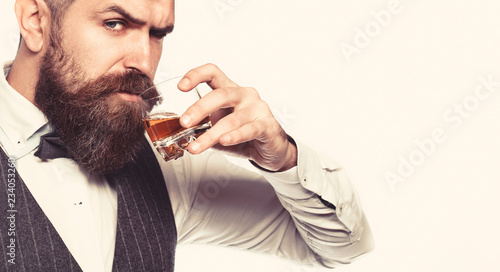 Whiskey, brandy, cognac drink. Brutal bearded man with glass of whiskey, brandy, cognac. Attractive man with a cognac. Old hipster style. photo