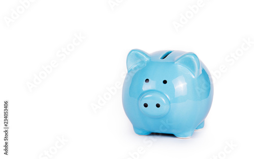 Blue piggy bank on white background. Concept money and finance. Copy space