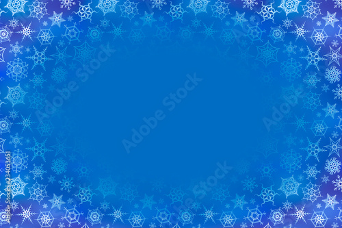 A lot of frozen snowflakes on blue winter background with text place