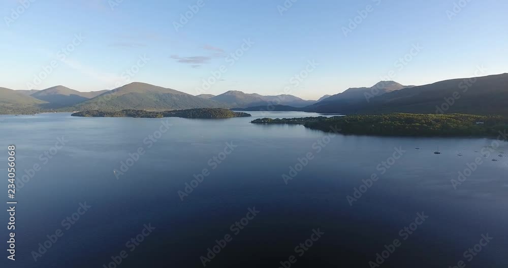Inspiring and mystic aerial view from a drone of Loch Lomond in Scotland - Summer time with blue sky Inspiring and mystic aerial view from a drone of Loch Lomond in Scotland - Summer time with blue sky