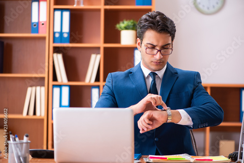 Young handsome businessman working in the office