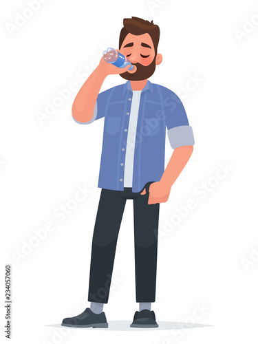 Handsome man drinking water from a bottle. Thirst