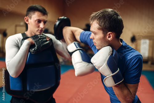 Male kickboxer in gloves practicing elbow kick © Nomad_Soul