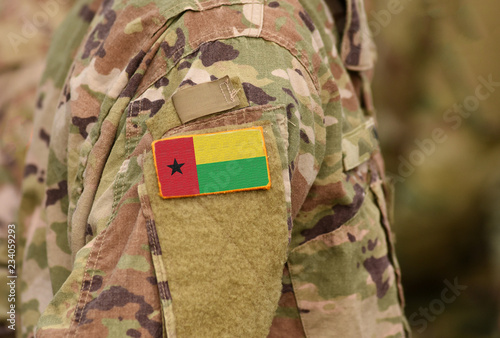 Guinea-Bissau flag on soldiers arm. Guinea-Bissau troops (collage) photo