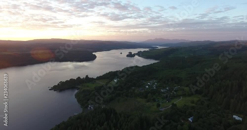 Inspiring Distant Green Landscape Drone Shot in Scotland with a Loch