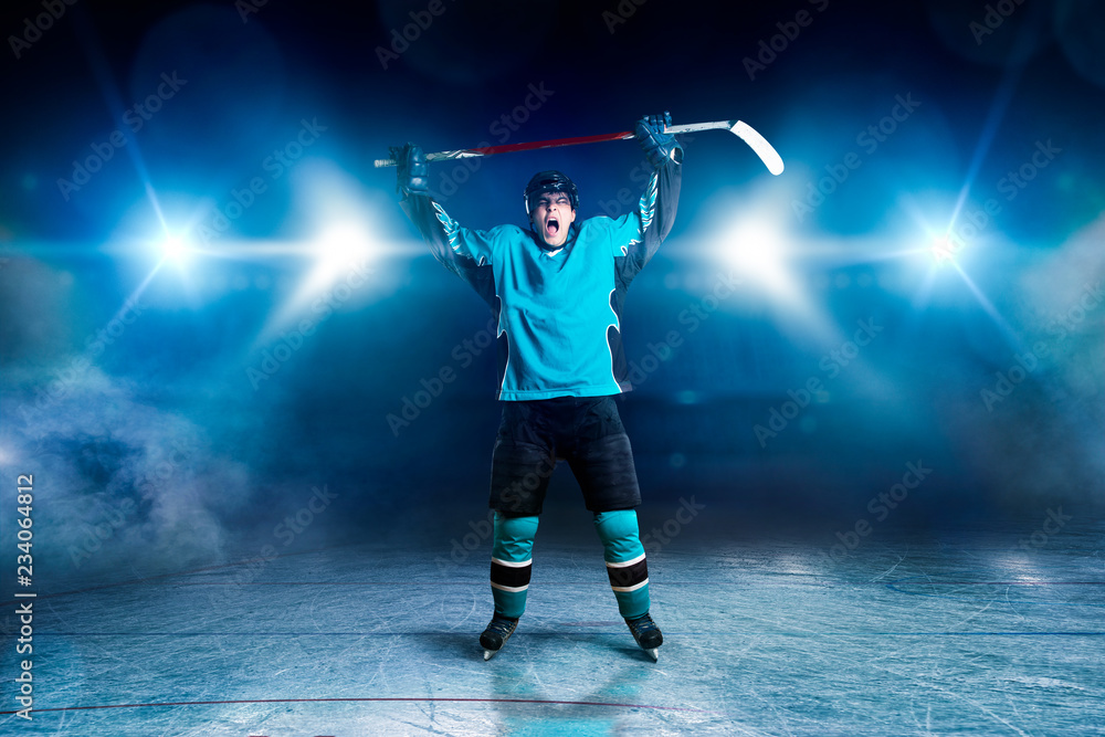 Fototapeta premium Hockey player raised his hands up, winner