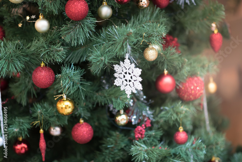 Decorated Christmas tree on blurred, sparkling and fairy background.