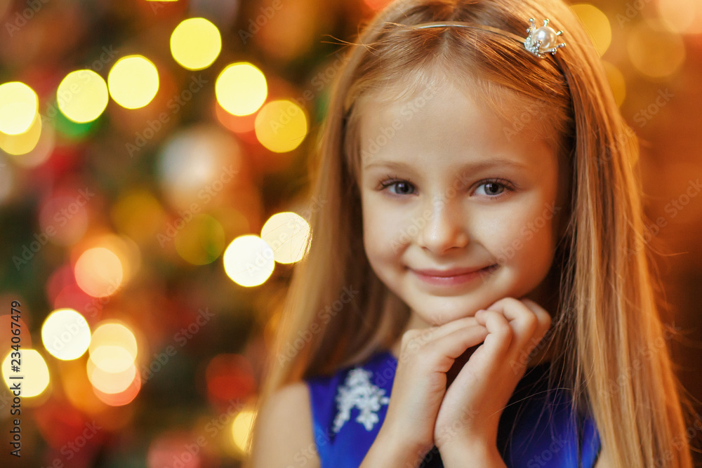 Little blonde girl in blue dress, new year Little blonde girl in blue dress, new year