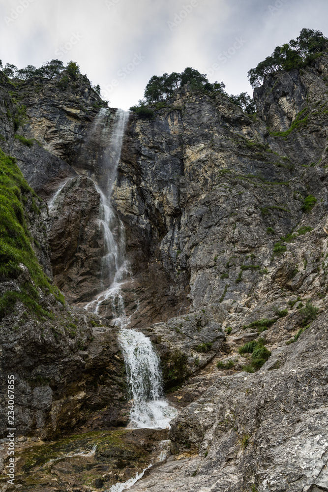 High waterfall with rocks around