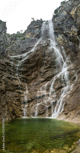 High waterfall with rocks around