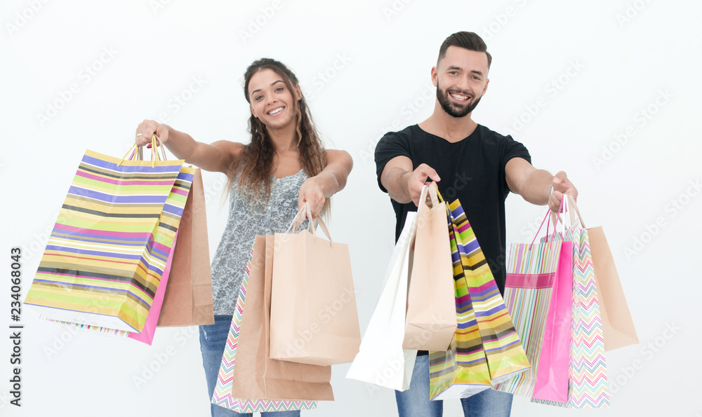 young couple shows shopping bags young couple shows shopping bags