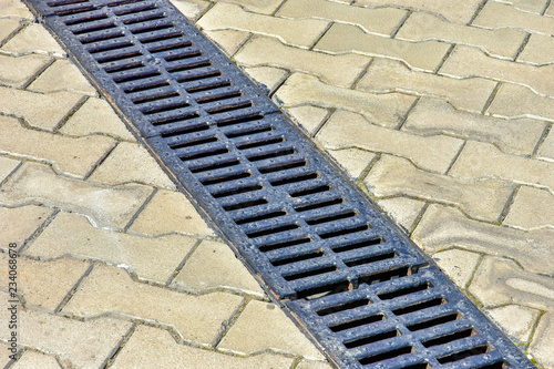 August 1, 2018. Krasnoyarsk. Russia. Improvement of the embankment of the Yenisei River. cast iron grid for water flow in sewers.