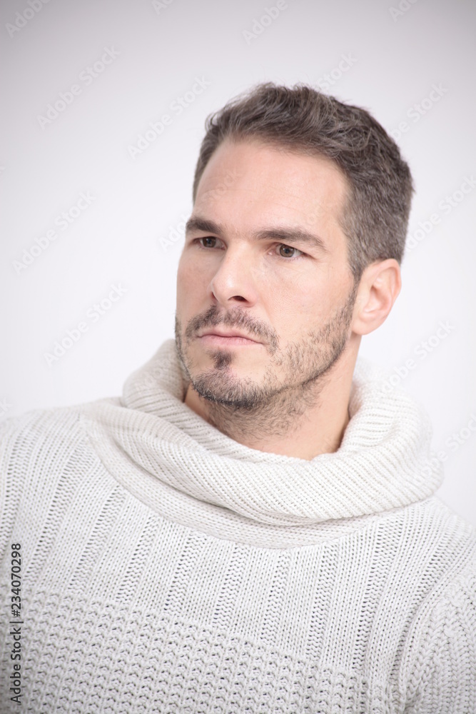 Fototapeta premium Man in a white sweater is watching
