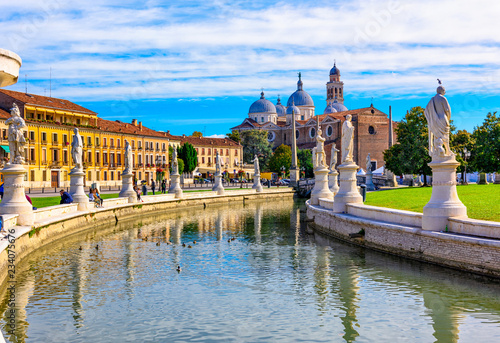View of canal with statues on square Prato della Valle and Basilica Santa Giustina in Padova (Padua), Veneto, Italy photo