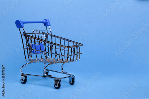 Shopping cart on blue background