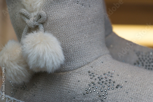 Fototapeta Naklejka Na Ścianę i Meble -  Close-up: warm knitted women's shoes. Concept: stay comfortable & cozy at home with winter holiday gift.