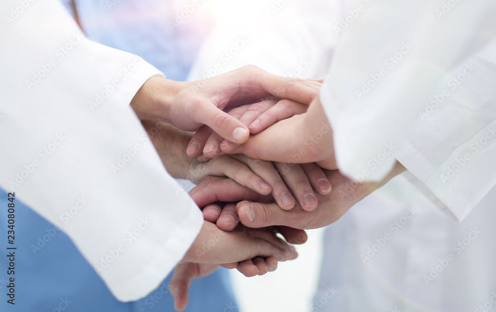 closeup.Small group of doctor team joining hands, closeup.Small group of doctor team joining hands,