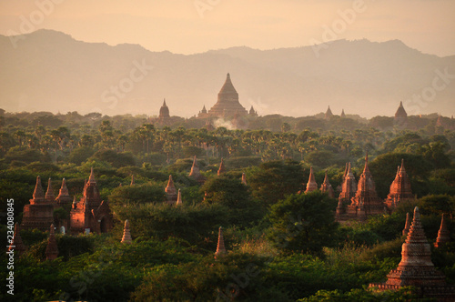 Green land with spears of temple, Picturesque landscape of green spacious terrain with spires of oriental pagodas and paya, Myanmar, Bagan. Mingalazedi Sulamani Shwezigon Ananda Htilominlo.