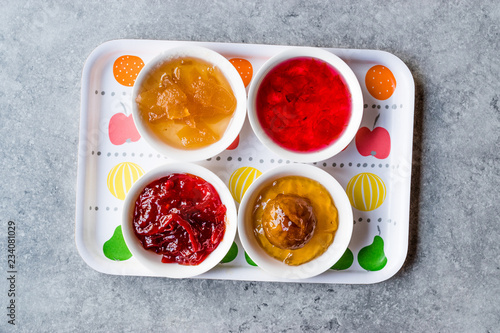 Assorted Variety of Jams and Marmalades;  Rose, Red Pepper, Mandarin and Citron Peel in Small Bowl.