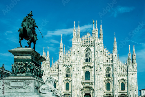Milan Cathedral (Duomo di Milano) and Vittorio Emanuele II equestrian statue at Cathedral square of Milan, Lombardy, Italy. Famous tourist attraction of Milan, Italy.