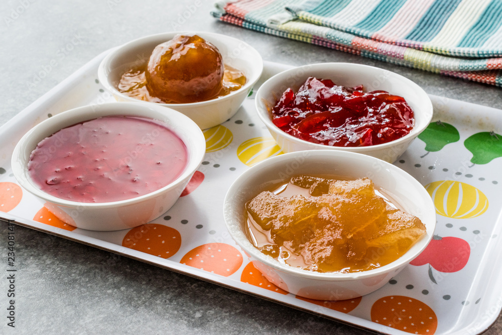 Assorted Variety of Jams and Marmalades; Rose, Red Pepper, Mandarin and Citron Peel in Small Bowl. Assorted Variety of Jams and Marmalades; Rose, Red Pepper, Mandarin and Citron Peel in Small Bowl.