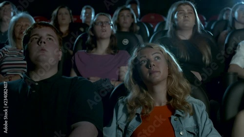 Pan across a young, captivated cinema audience. photo