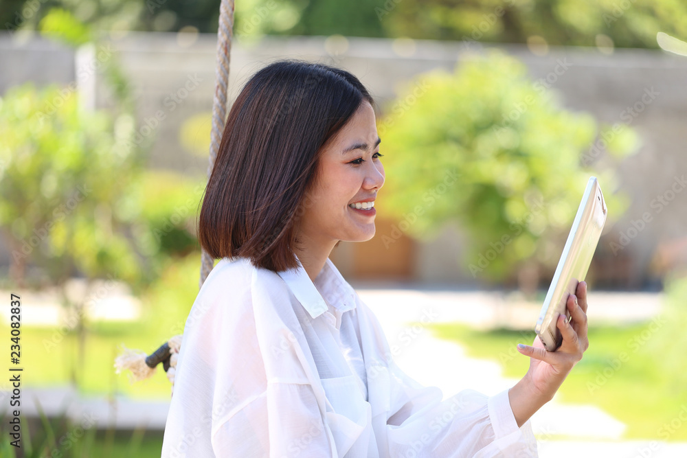 Happy hipster girl hand holding tablet smart device of social media and communication technology concept Happy hipster girl hand holding tablet smart device of social media and communication technology concept
