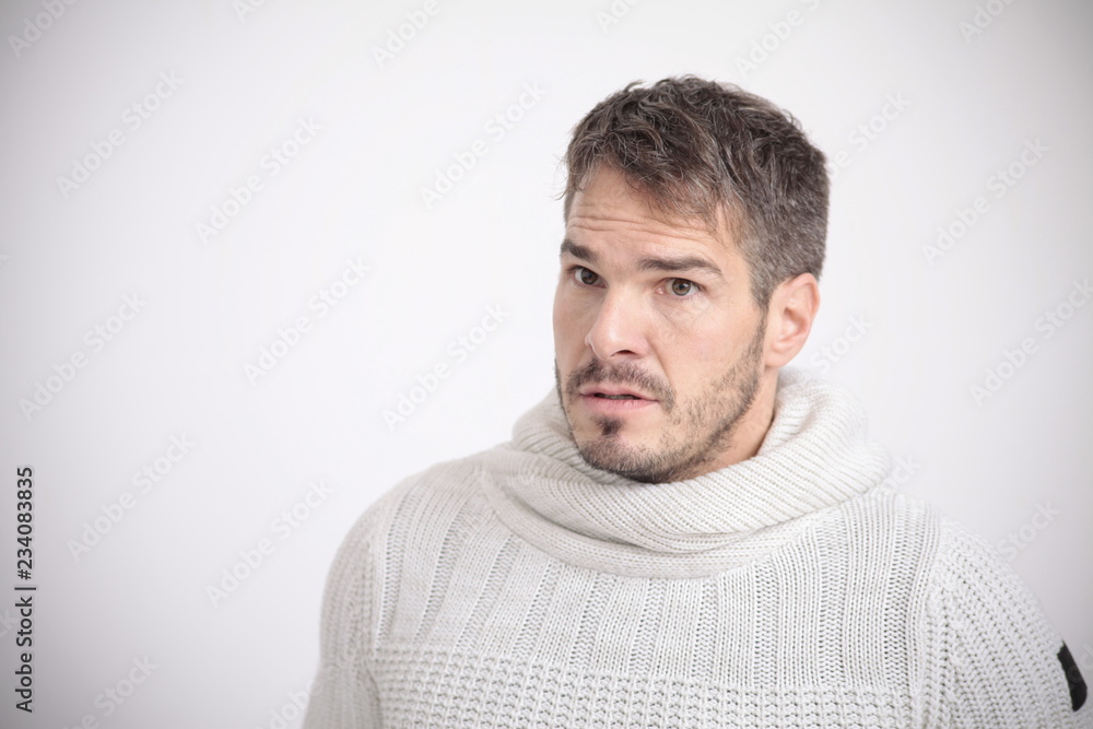 Man in white shirt looking scared in front of a white background Man in white shirt looking scared in front of a white background