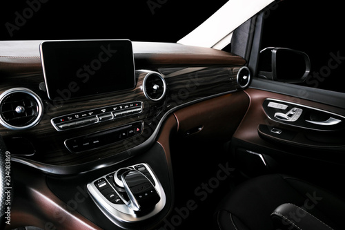 Modern Luxury car inside. Interior of prestige car. Comfortable leather seats. Brown perforated leather cockpit with stitching. Steering wheel and dashboard. Automatic gear stick shift. Car detailing © Aleksei