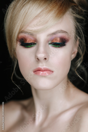 Teenage girl portrait looking down. Beauty Make-up with glitter brown and green eye shadows