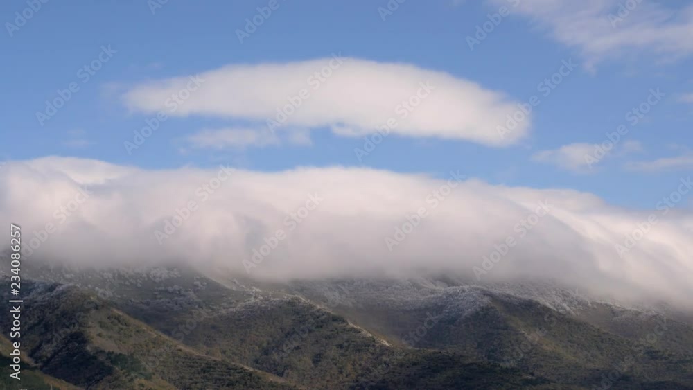 Tops of mountains in low thick clouds and trees covered with hoarfrost, morning hills panorama Tops of mountains in low thick clouds and trees covered with hoarfrost, morning hills panorama