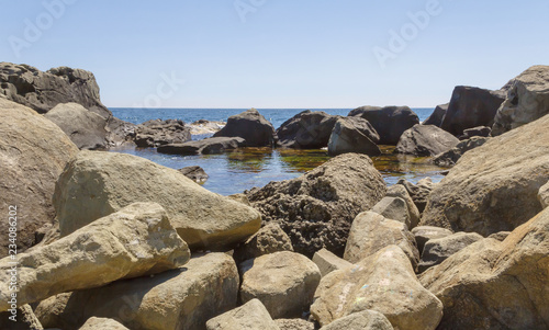 Stone chaos on the shore of the Black sea,forming small backwater.Crimea.