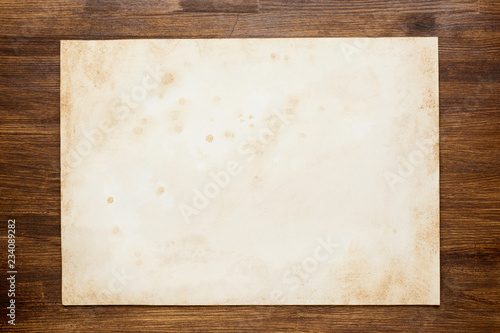 old blank paper on wooden background. Top view.