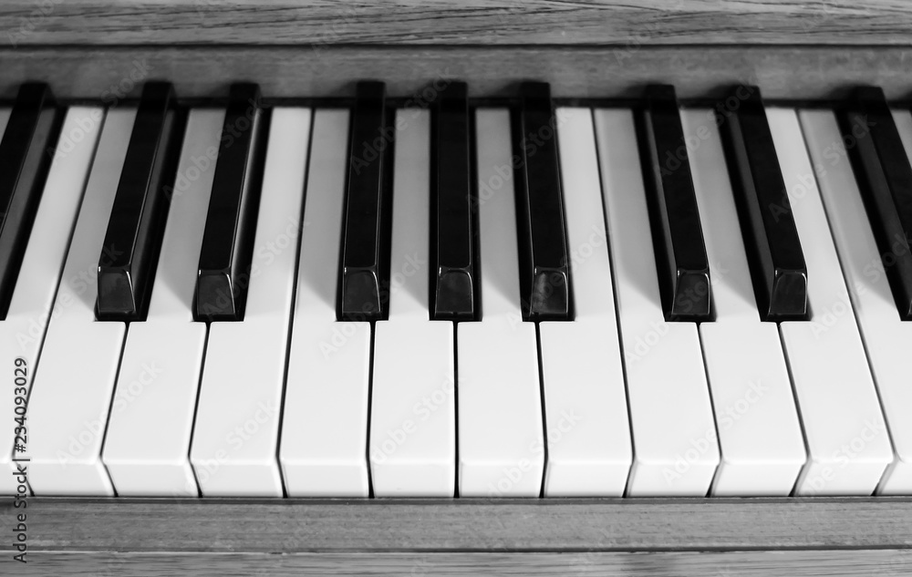 black and white photo of piano keys, shot from above black and white photo of piano keys, shot from above