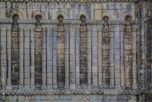 Canvas Print Many Old Columns on Block Wall in English